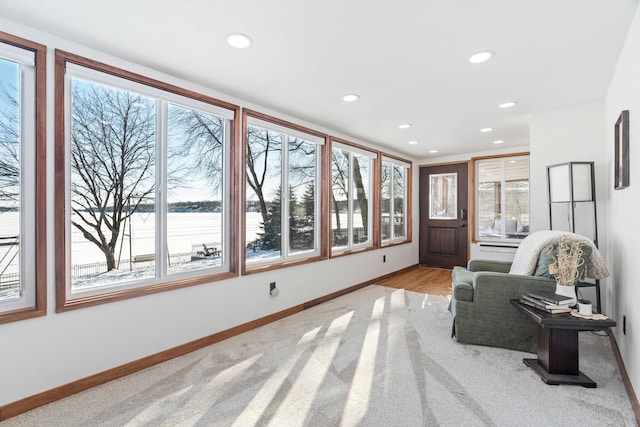 sitting room featuring light colored carpet, recessed lighting, and baseboards