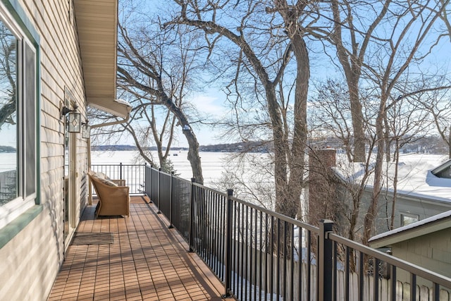 snow covered deck with a water view