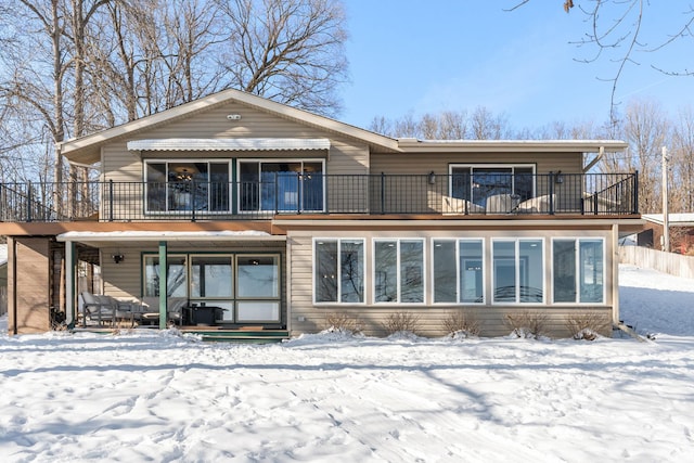 snow covered property featuring a balcony