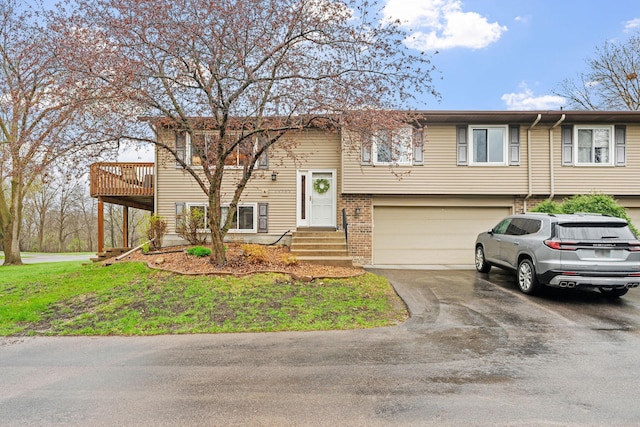 raised ranch with a garage and driveway