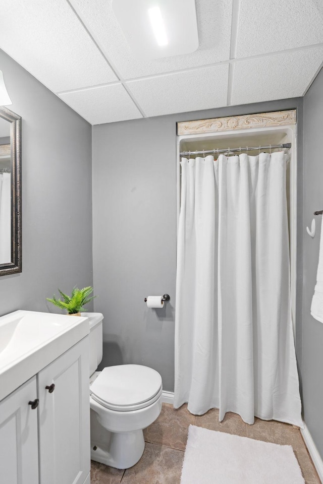 bathroom with vanity, baseboards, and toilet