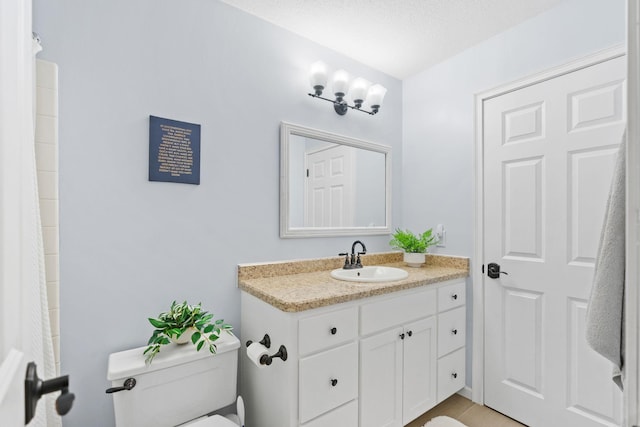 full bath featuring toilet, a textured ceiling, a shower with shower curtain, and vanity