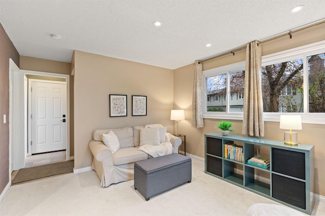 living area featuring recessed lighting, a textured ceiling, baseboards, and carpet