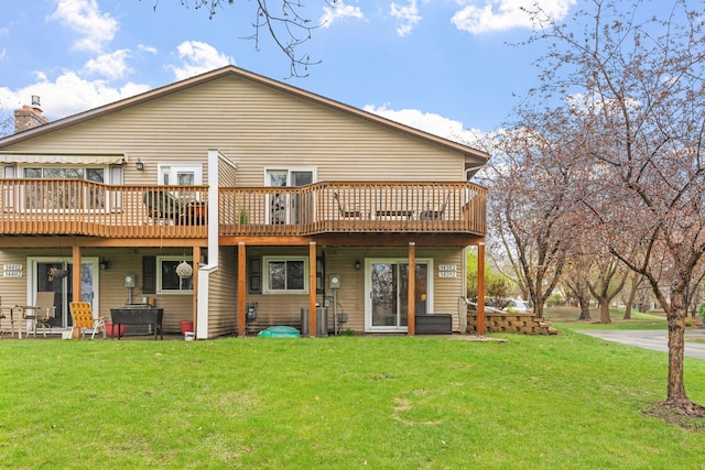 back of property featuring a yard and a deck
