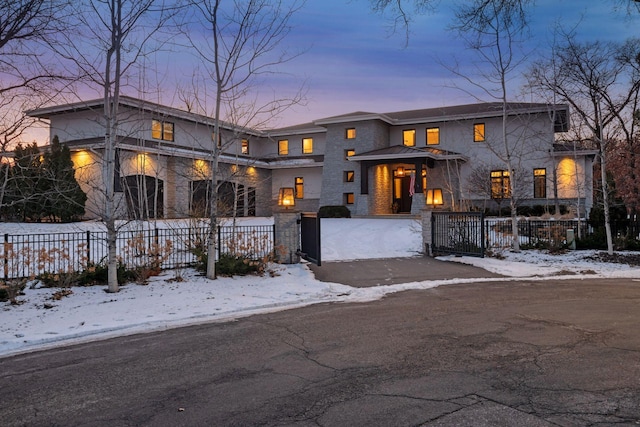 view of front of house with stone siding and a fenced front yard