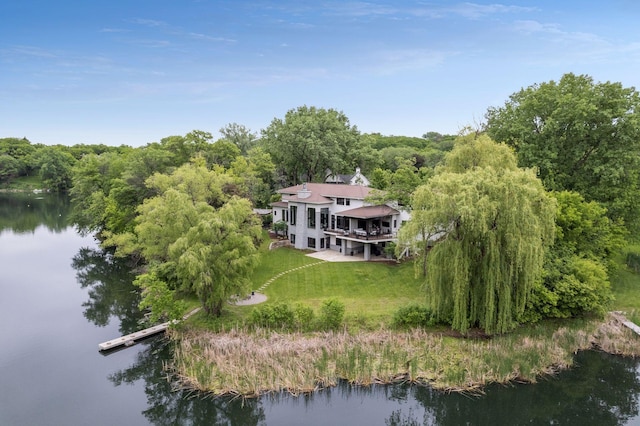 drone / aerial view featuring a water view and a forest view