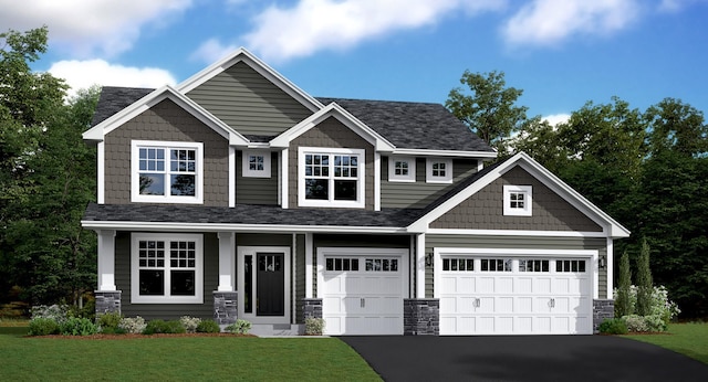 craftsman inspired home featuring a garage and a front lawn