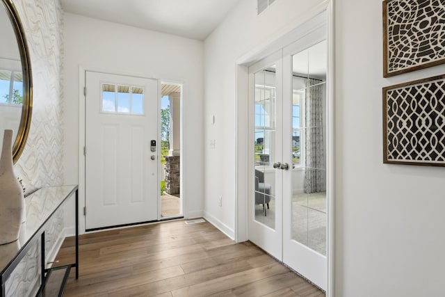 entryway with light hardwood / wood-style flooring and french doors