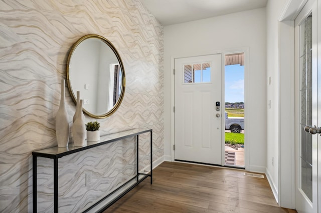 foyer entrance with wood-type flooring