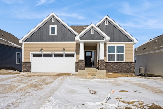 craftsman-style home featuring stone siding and central AC