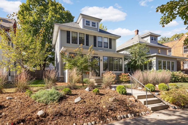 american foursquare style home featuring fence