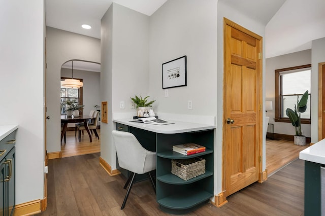 dining area with dark wood finished floors and baseboards