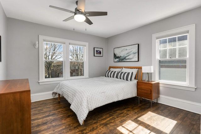 bedroom featuring wood finished floors, baseboards, and ceiling fan