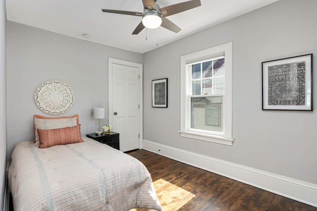 bedroom featuring dark wood-type flooring, a ceiling fan, and baseboards