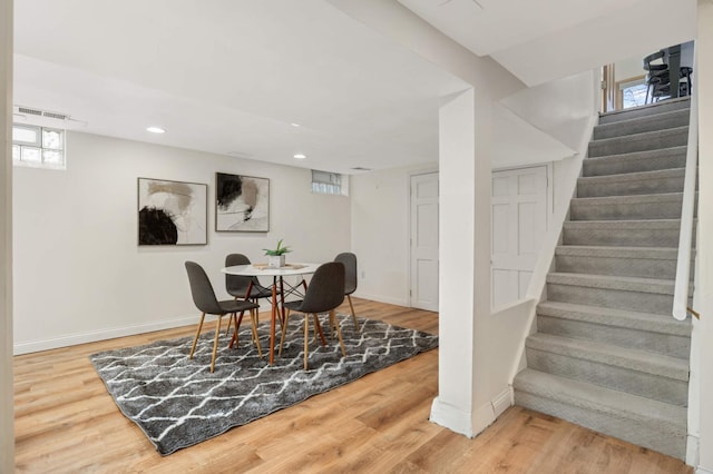 dining space with stairs, recessed lighting, wood finished floors, and baseboards