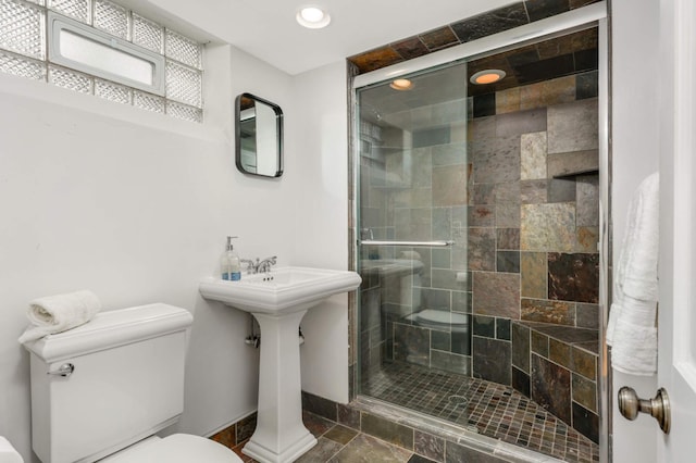 bathroom with recessed lighting, a stall shower, toilet, and baseboards