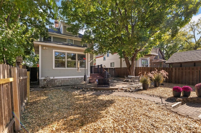 rear view of property with a patio area and a fenced backyard