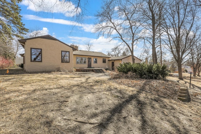 back of house with brick siding