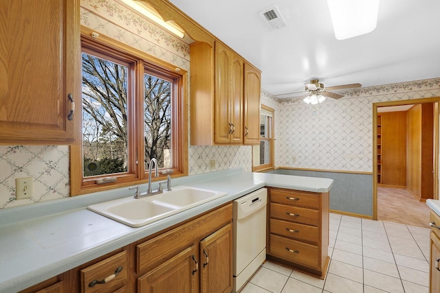 kitchen with visible vents, dishwasher, wallpapered walls, and a sink