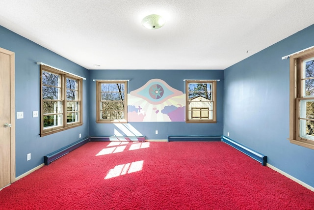 carpeted empty room with a baseboard radiator, baseboards, a textured ceiling, and baseboard heating