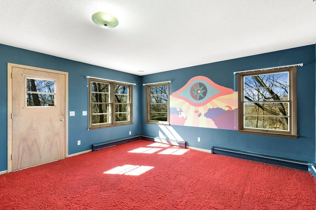 carpeted empty room with baseboards, baseboard heating, and a textured ceiling