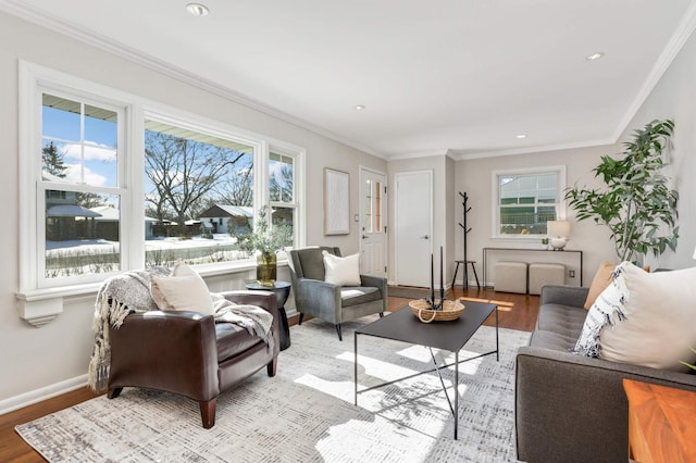 living room with light wood-style floors, baseboards, and ornamental molding