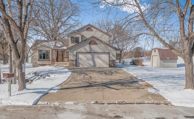 view of front of home featuring a storage shed, driveway, and an attached garage