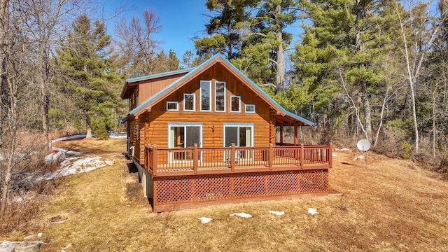 rear view of house with a deck and log siding