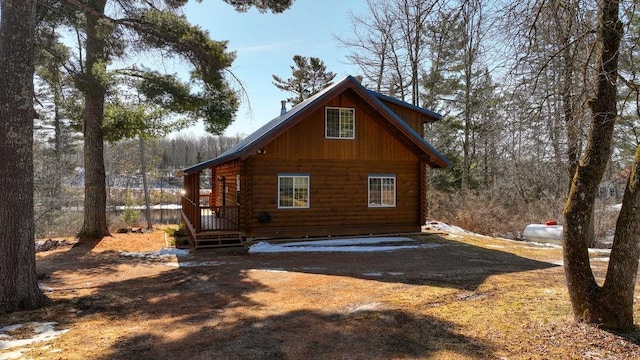 rear view of property featuring log siding