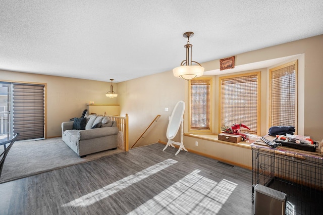 interior space featuring a textured ceiling and hardwood / wood-style floors