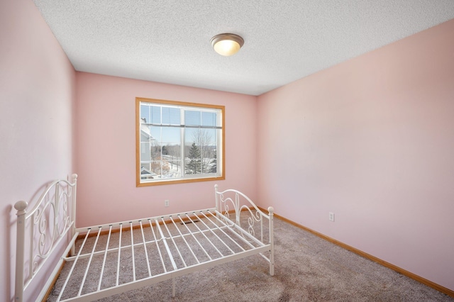 unfurnished bedroom featuring carpet floors and a textured ceiling