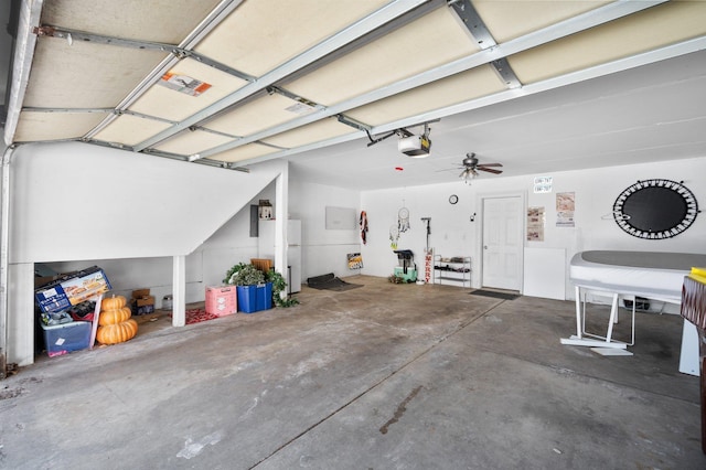 garage featuring a garage door opener and white refrigerator