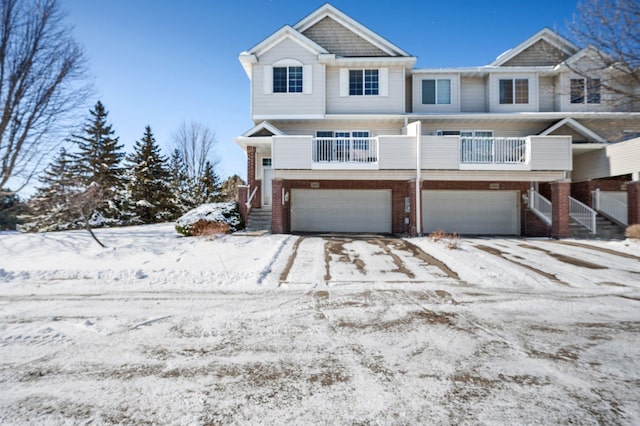 view of front of home with a garage and a balcony