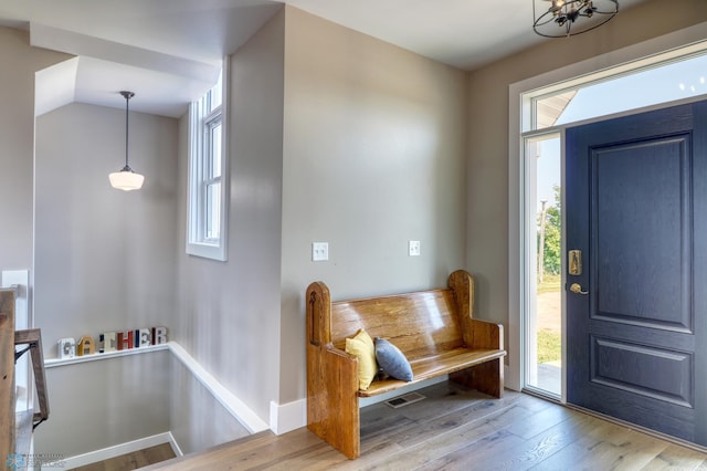 foyer entrance featuring vaulted ceiling, wood finished floors, and baseboards