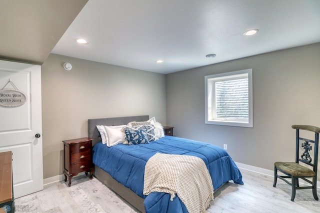 bedroom with recessed lighting, wood finished floors, and baseboards