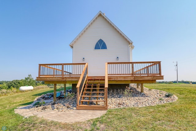 back of house with a deck, a yard, and stairway