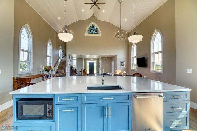 kitchen featuring light wood-type flooring, built in microwave, open floor plan, and a sink