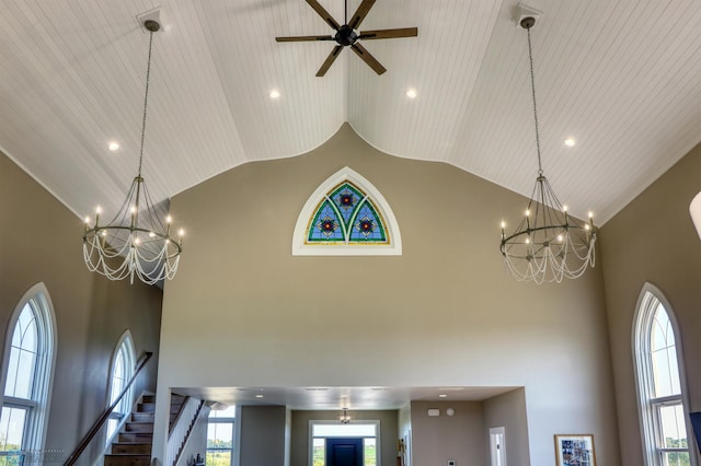 interior details with ceiling fan with notable chandelier