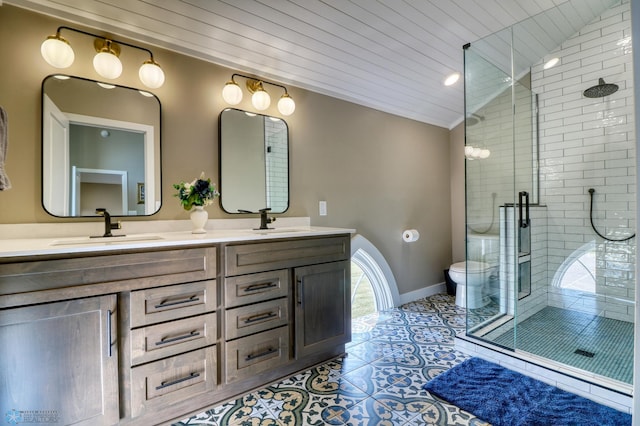 full bathroom featuring baseboards, vaulted ceiling, a sink, and tile patterned floors