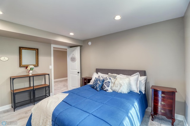 bedroom featuring baseboards, wood finished floors, and recessed lighting