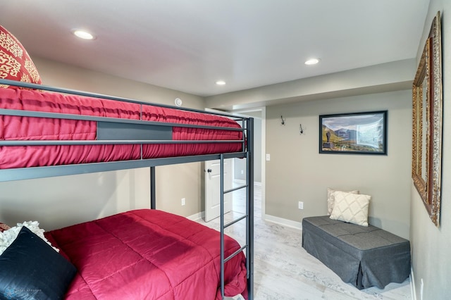 bedroom featuring baseboards, wood finished floors, and recessed lighting