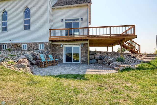 back of property featuring a patio, a shingled roof, a lawn, stairway, and a wooden deck