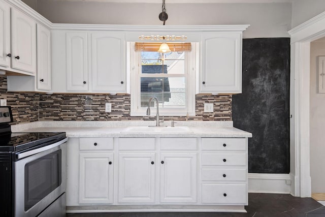 kitchen with light countertops, white cabinets, stainless steel electric range oven, and a sink