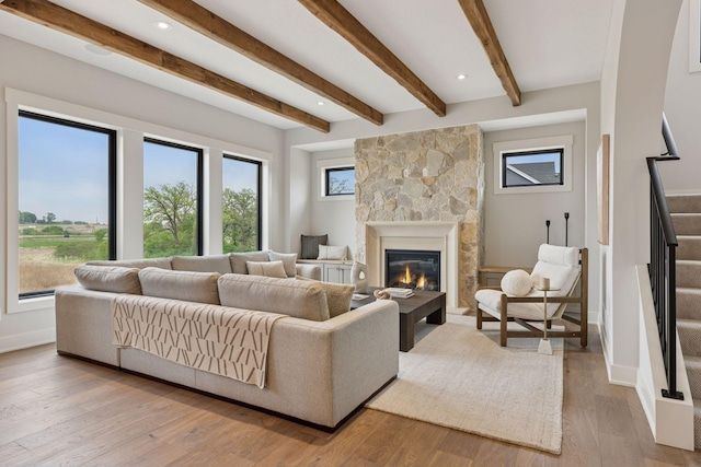 5455 Rolling Hills Pkwy, Victoria, MN 55318 - living area featuring healthy amount of natural light, a fireplace, hardwood / wood-style floors, beam ceiling, and baseboards