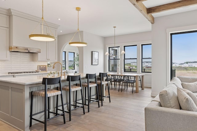 5455 Rolling Hills Pkwy, Victoria, MN 55318 - kitchen with tasteful backsplash, light wood-style flooring, recessed lighting, stainless steel gas stovetop, and open floor plan