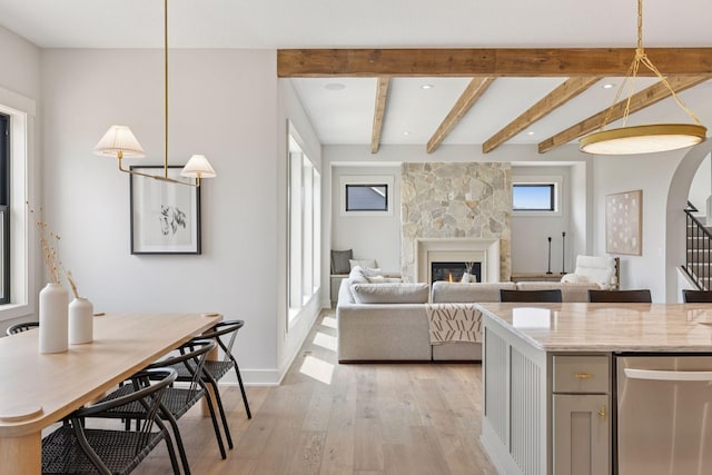 5455 Rolling Hills Pkwy, Victoria, MN 55318 - kitchen with light wood finished floors, dishwasher, a large fireplace, hanging light fixtures, and beam ceiling