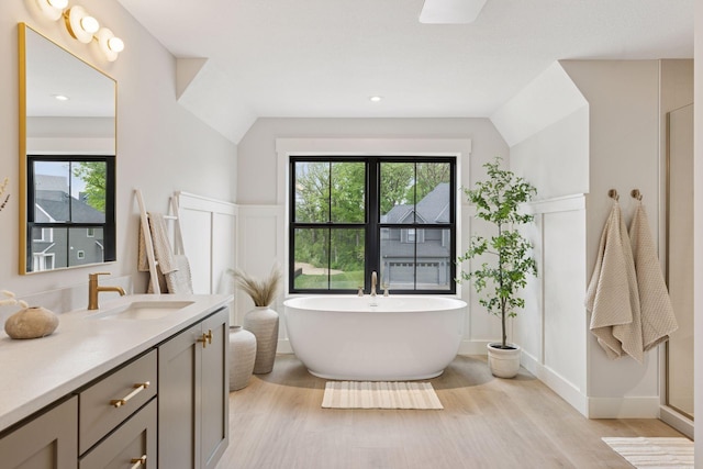 5455 Rolling Hills Pkwy, Victoria, MN 55318 - bathroom with wood finished floors, vanity, and a freestanding bath