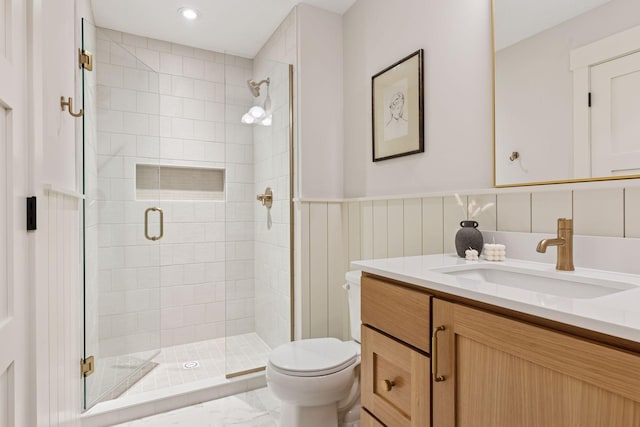 5455 Rolling Hills Pkwy, Victoria, MN 55318 - bathroom featuring toilet, a shower stall, vanity, marble look tile flooring, and wainscoting