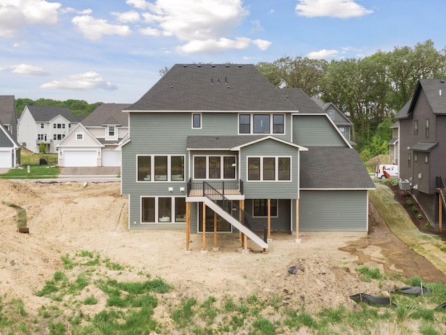 5455 Rolling Hills Pkwy, Victoria, MN 55318 - back of house with stairway, roof with shingles, a residential view, a wooden deck, and a sunroom
