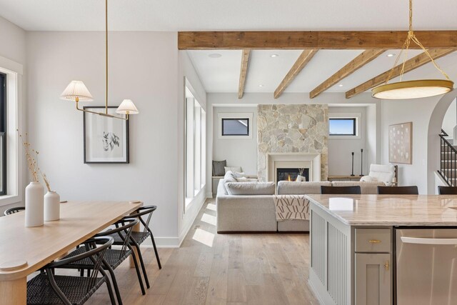 5455 Rolling Hills Pkwy, Victoria, MN 55318 - kitchen featuring light wood-style floors, dishwasher, a large fireplace, pendant lighting, and beamed ceiling
